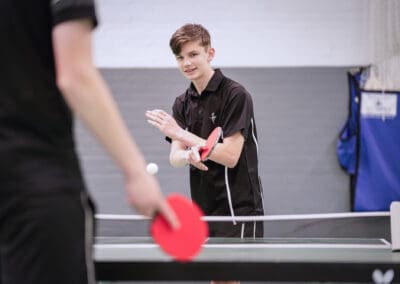 Two people play table tennis at club cheadle hulme.